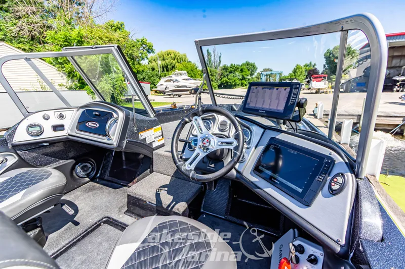 Slide: The Image of 2020 Triton 216 Fishunter boat interior with modern dashboard and navigation equipment. - 14