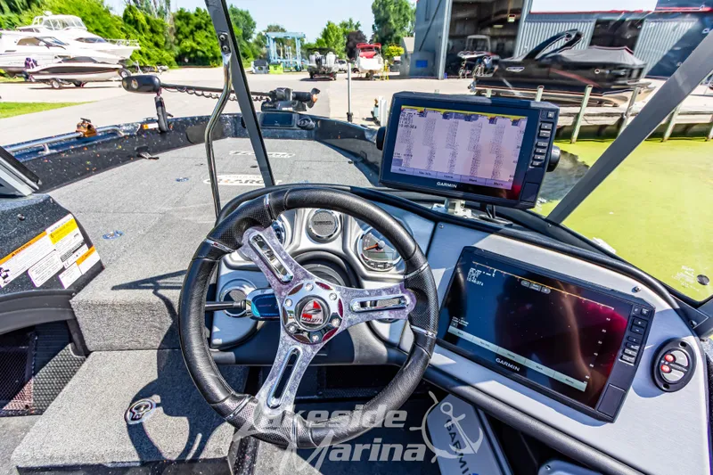 Slide: The Image of 2020 Triton 216 Fishunter boat dashboard with Garmin navigation systems and steering wheel. - 15