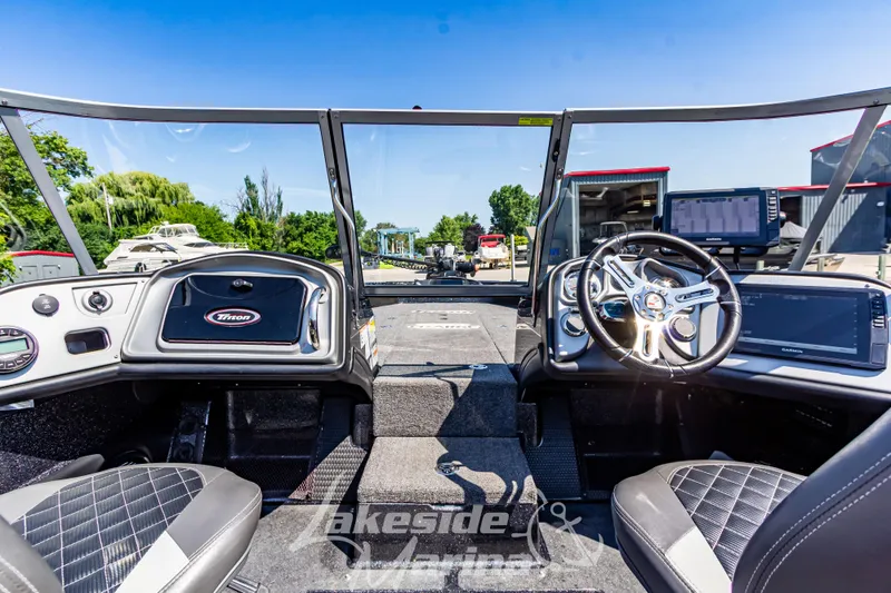 Slide: The Image of 2020 Triton 216 Fishunter boat interior with steering wheel and dashboard controls. - 22