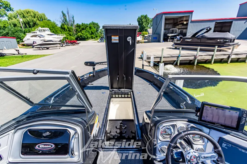 Slide: The Image of 2020 Triton 216 Fishunter boat interior at Lakeside Marina, featuring dashboard and open storage. - 24