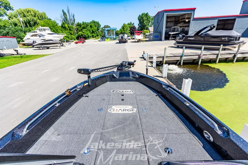 Slide: The Image of 2020 Triton 216 Fishunter boat at Lakeside Marina, docked near other boats. - 25