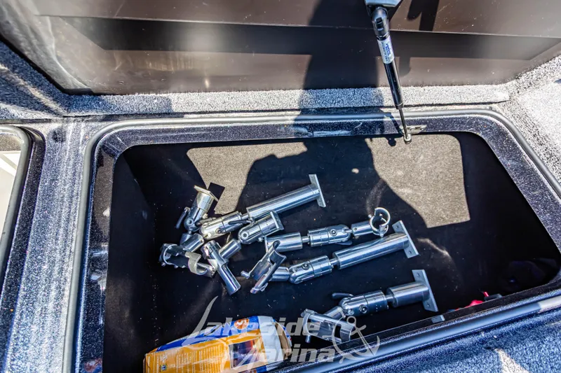 Slide: The Image of Open storage compartment in 2020 Triton 216 Fishunter boat with metal parts inside. - 27