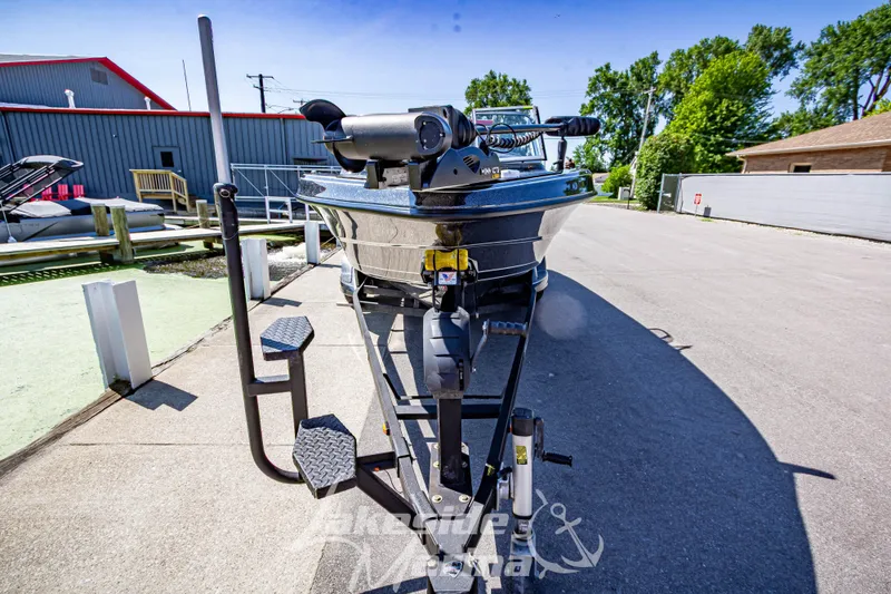 Slide: The Image of 2020 Triton 216 Fishunter boat on trailer, parked outdoors near marina. - 8