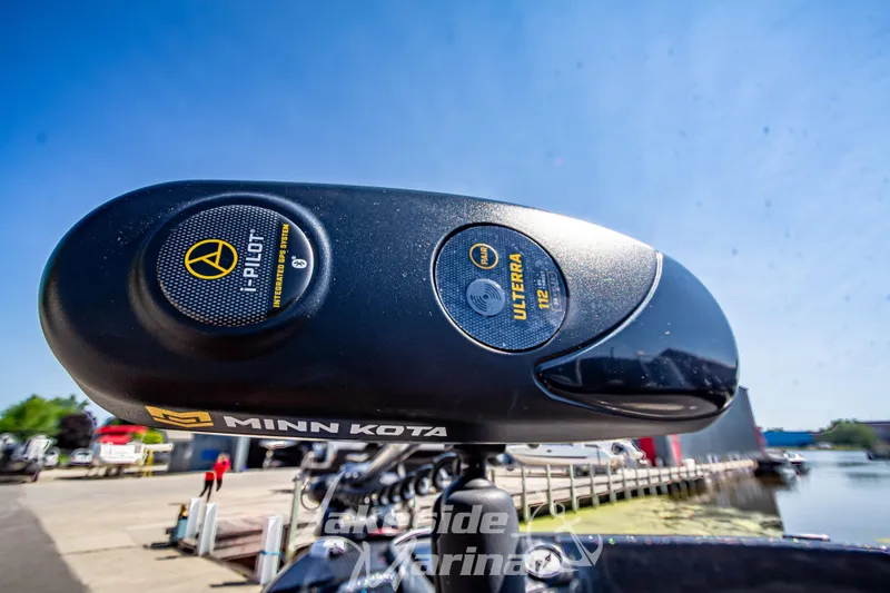 Slide: The Image of Minn Kota Ulterra motor on 2020 Triton 216 Fishunter boat at lakeside marina. - 9