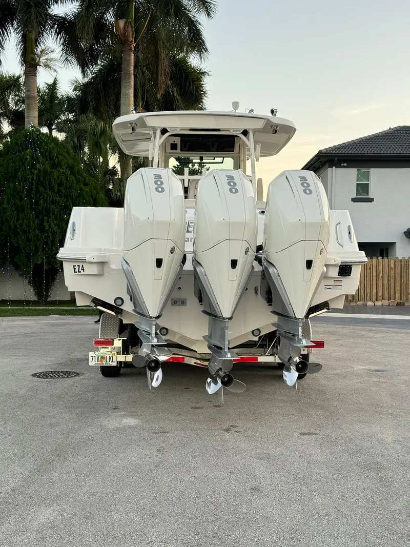 Slide: The Image of 2021 Boston Whaler 350 Outrage with triple outboard engines, rear view. - 11