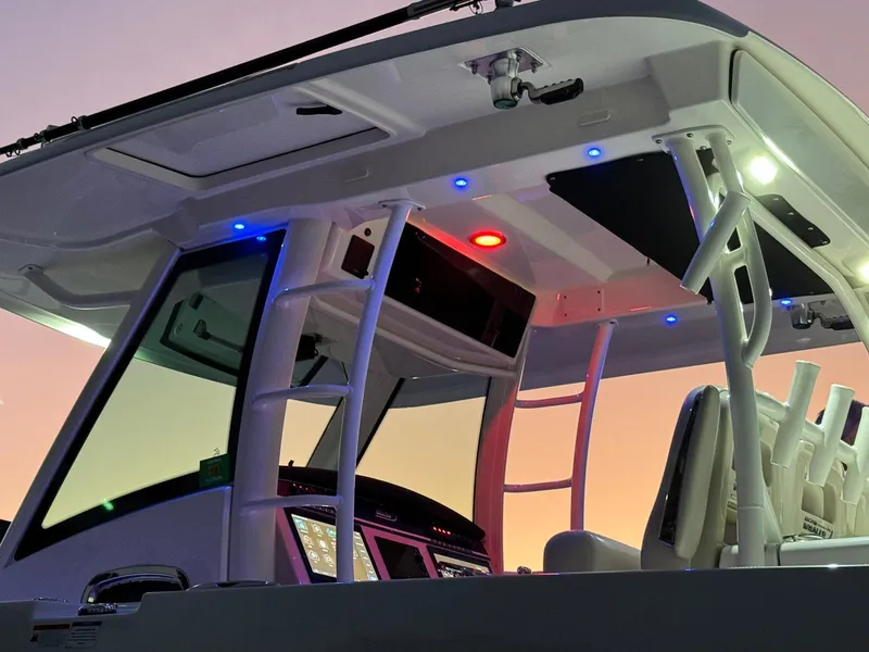 Slide: The Image of 2021 Boston Whaler 350 Outrage boat interior with illuminated console and seating. - 17