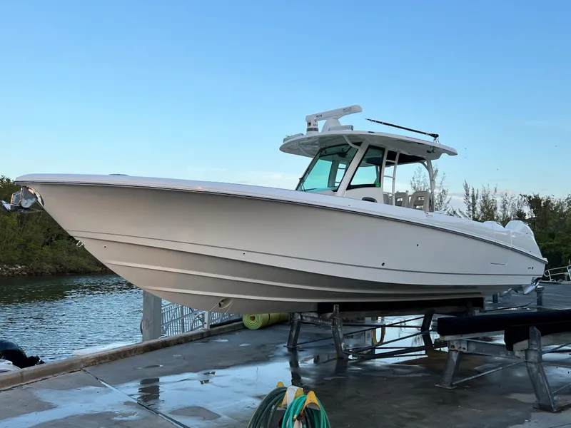 Slide: The Image of Boston Whaler 350 Outrage 2021 on a dock by the water. - 2