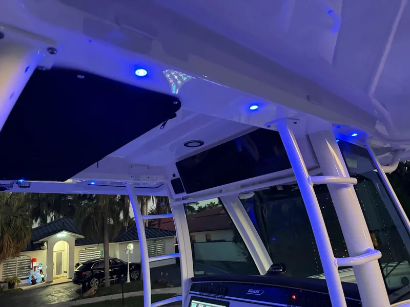 Slide: The Image of Interior view of 2021 Boston Whaler 350 Outrage with blue LED lights. - 22
