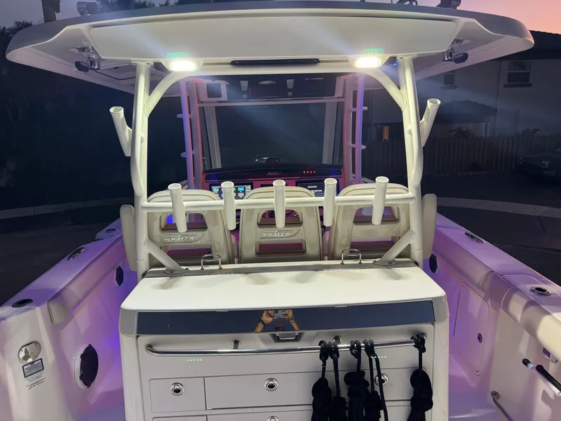 Slide: The Image of 2021 Boston Whaler 350 Outrage boat interior with illuminated seating and storage compartments. - 23