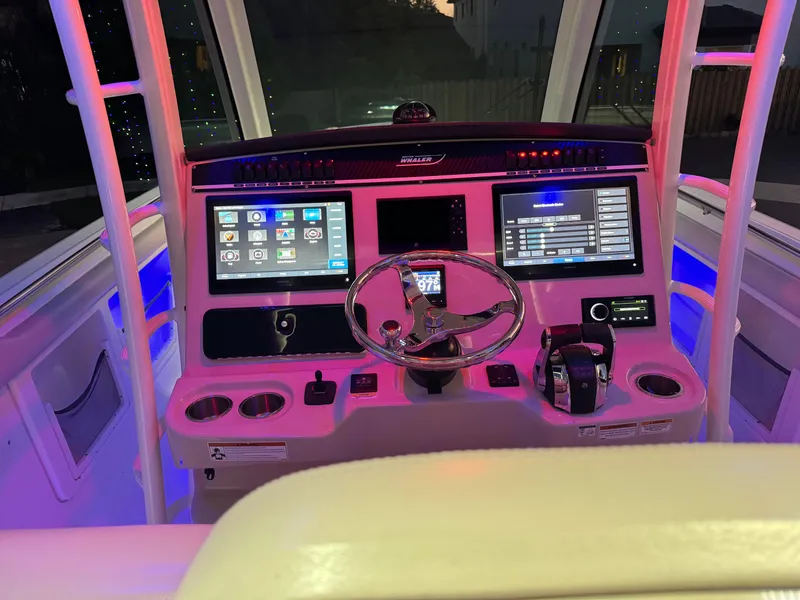 Slide: The Image of 2021 Boston Whaler 350 Outrage helm with dual displays and illuminated controls. - 24