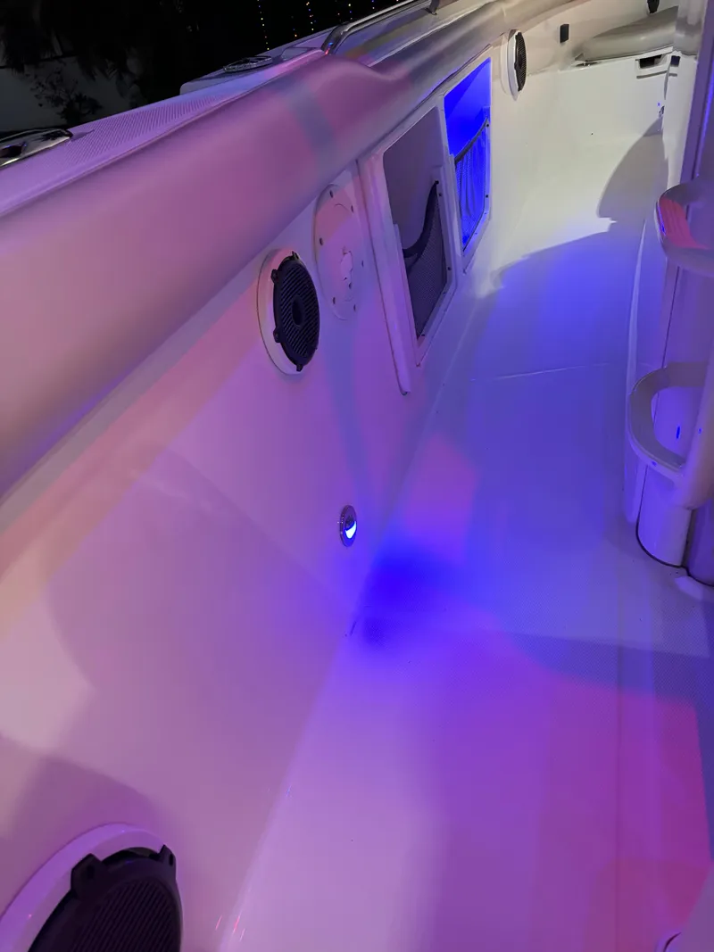 Slide: The Image of 2021 Boston Whaler 350 Outrage boat interior with blue LED lighting. - 25