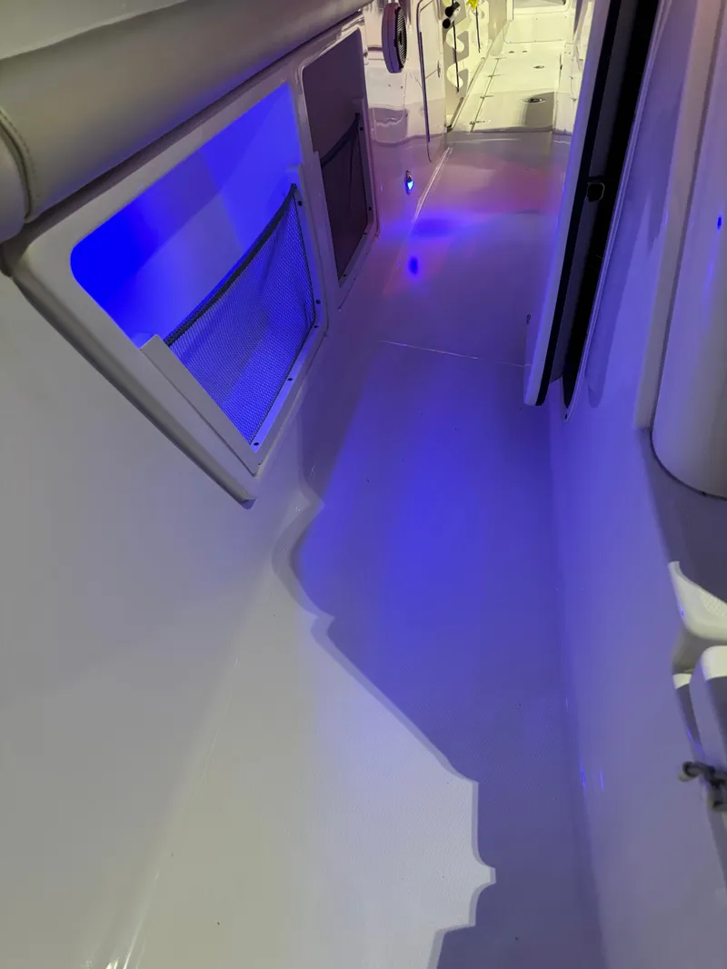 Slide: The Image of 2021 Boston Whaler 350 Outrage interior with blue LED lighting. - 27