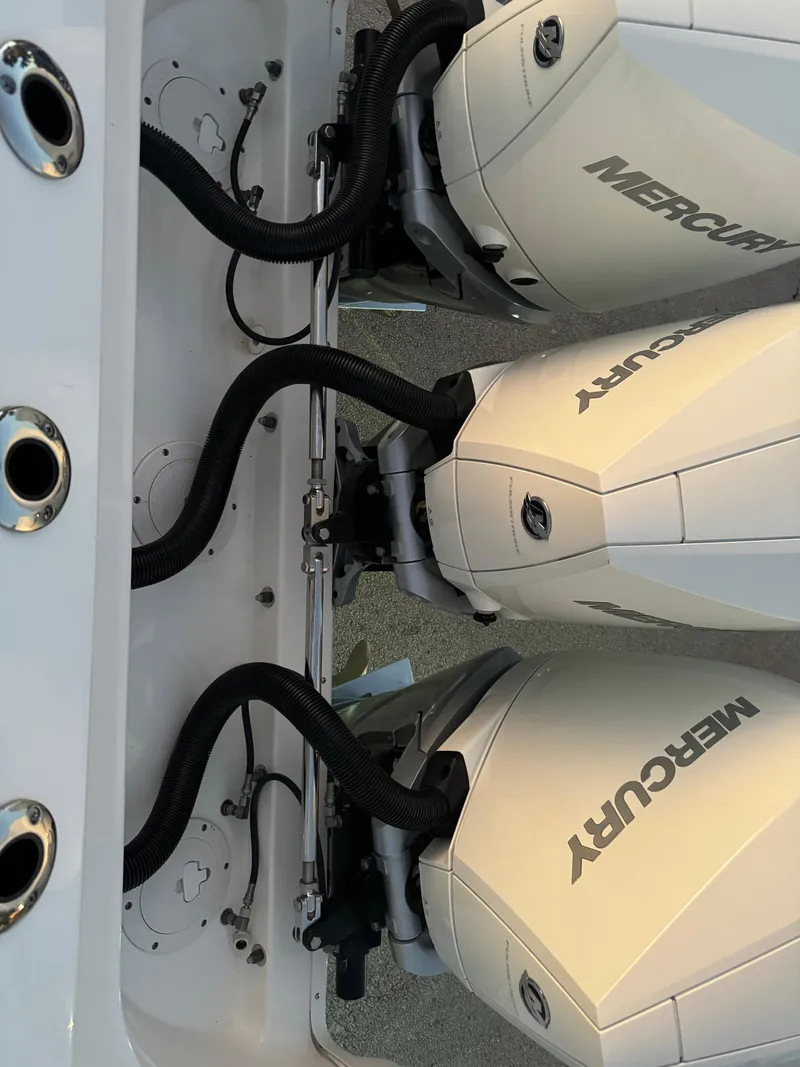 Slide: The Image of Twin Mercury outboard engines on a 2021 Boston Whaler 350 Outrage boat. - 28