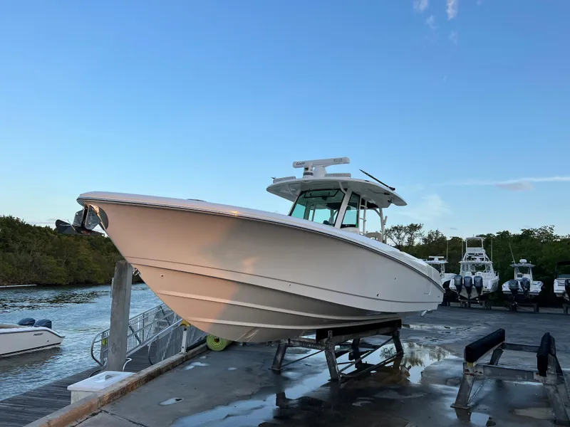 Slide: The Image of Boston Whaler 350 Outrage 2021 on a dock at sunset. - 3