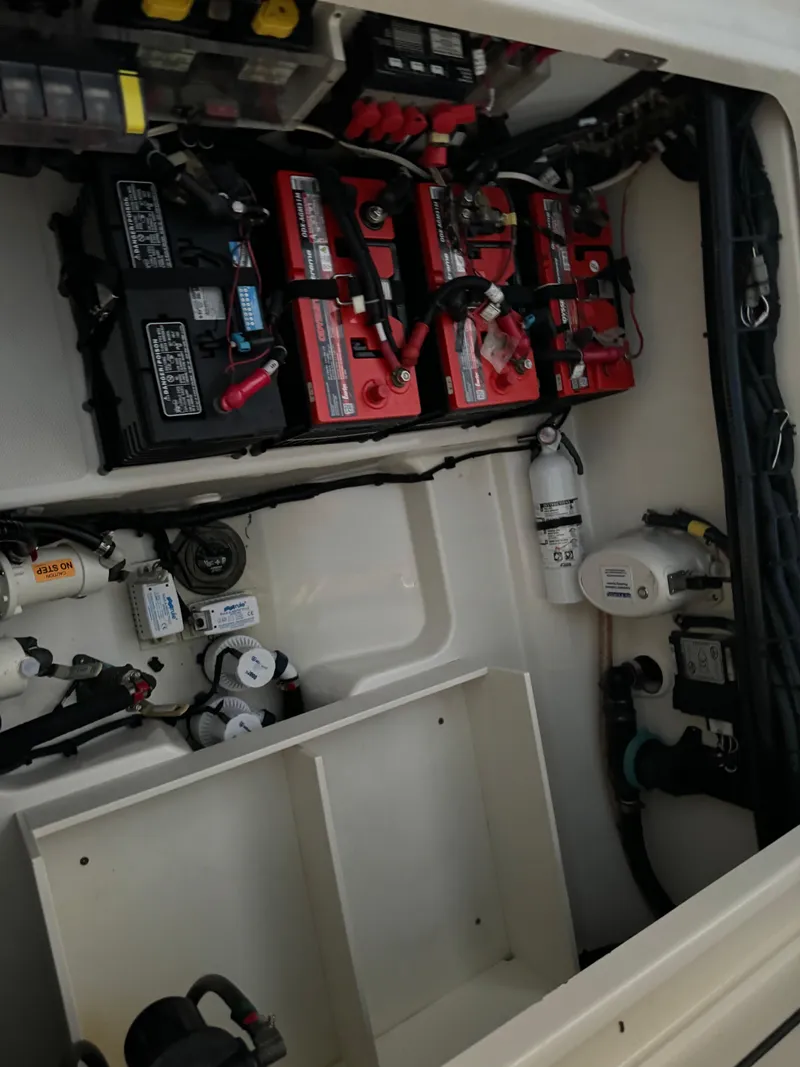 Slide: The Image of 2021 Boston Whaler 350 Outrage engine compartment with batteries and electrical components. - 30