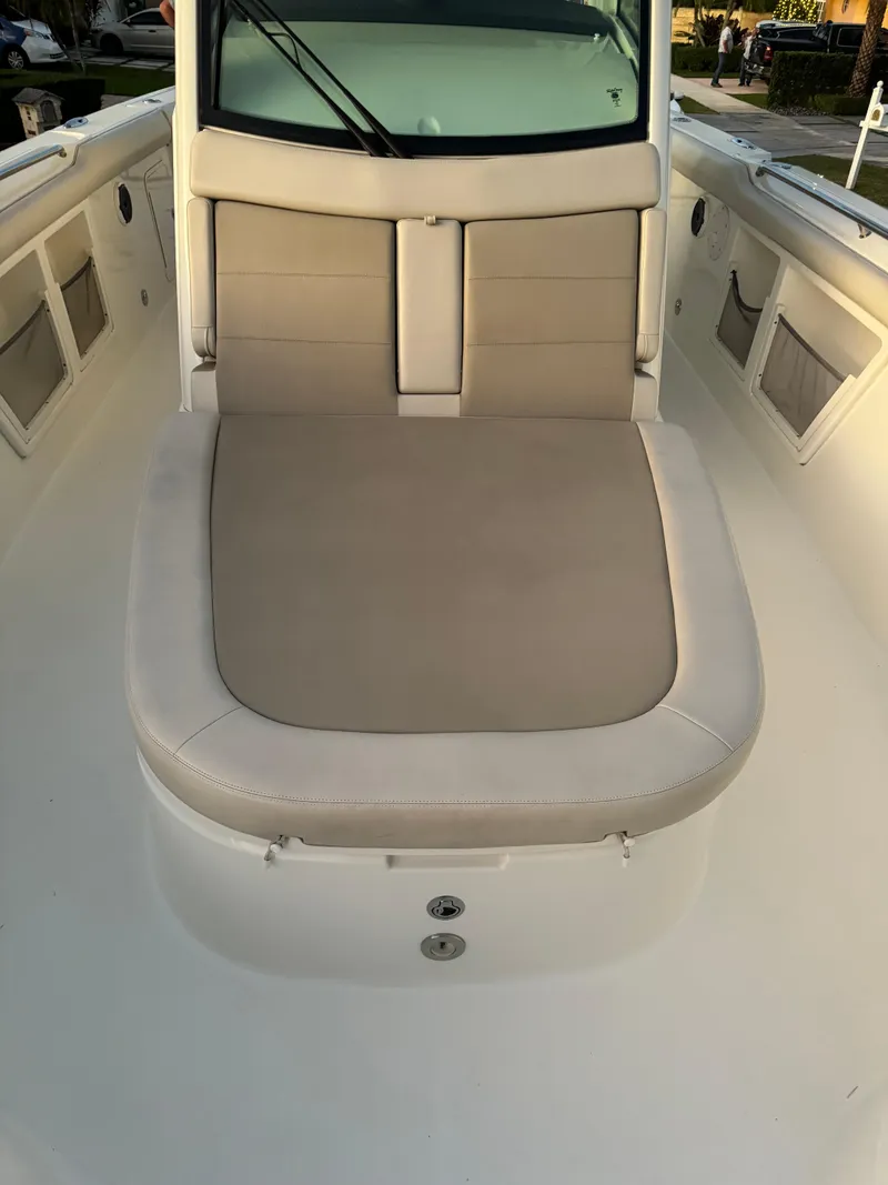 Slide: The Image of 2021 Boston Whaler 350 Outrage boat with cushioned seating area. - 33