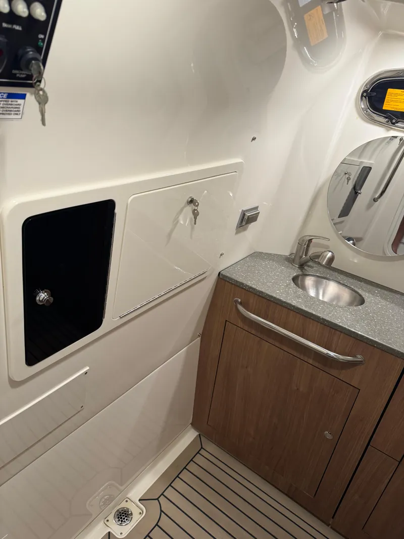 Slide: The Image of 2021 Boston Whaler 350 Outrage boat interior with sink and storage. - 36