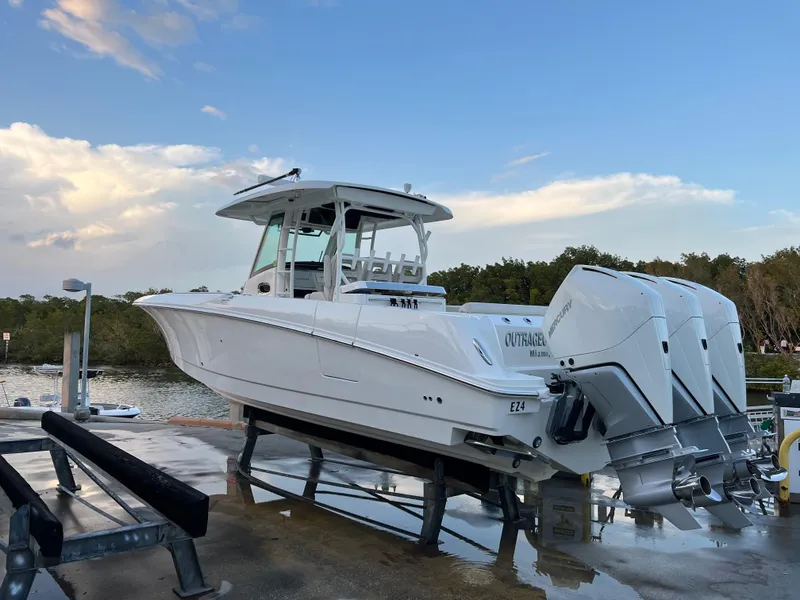 Slide: The Image of 2021 Boston Whaler 350 Outrage boat on a lift at a marina. - 4