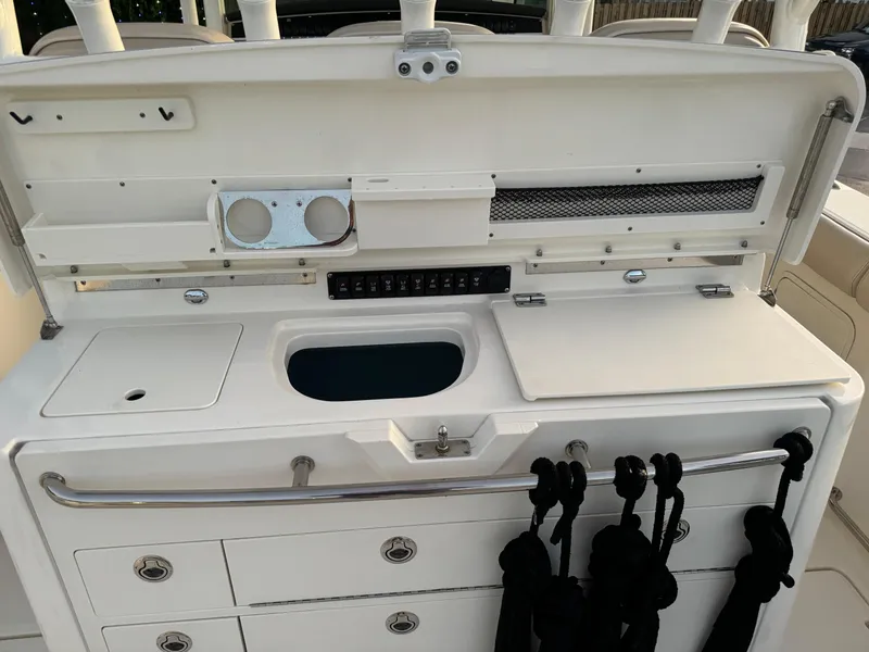 Slide: The Image of 2021 Boston Whaler 350 Outrage fishing station with storage compartments and rod holders. - 47