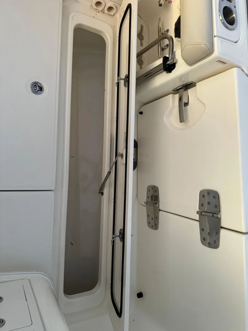 Slide: The Image of 2021 Boston Whaler 350 Outrage storage compartment and seating area. - 49