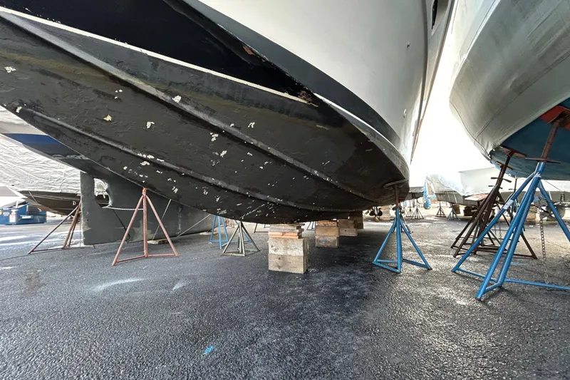 Slide: The Image of 1983 Silverton 34 Convertible boat on stands, hull view in dry dock. - 10