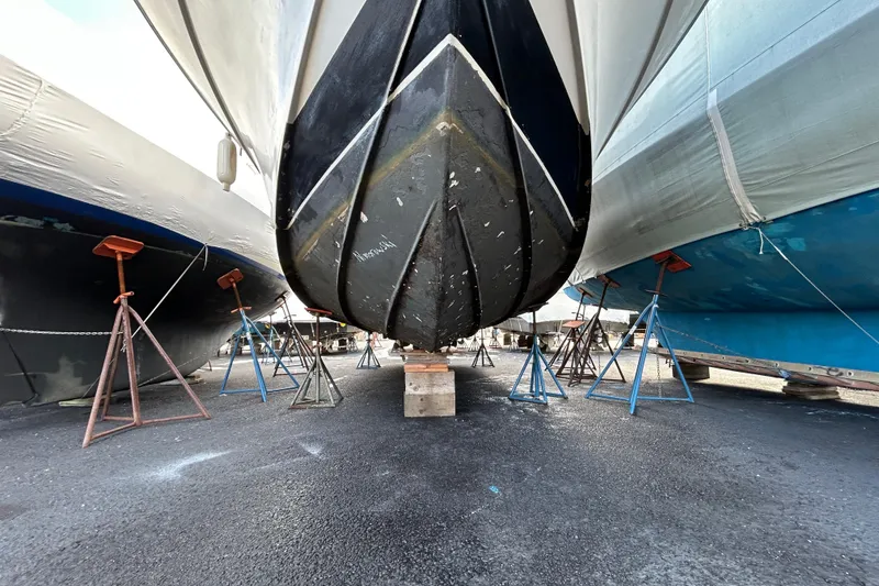 Slide: The Image of 1983 Silverton 34 Convertible boat on stands in a shipyard. - 11