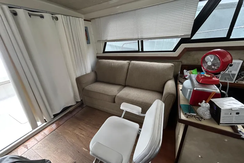 Slide: The Image of Interior of 1983 Silverton 34 Convertible with sofa, chair, and red fan. - 27