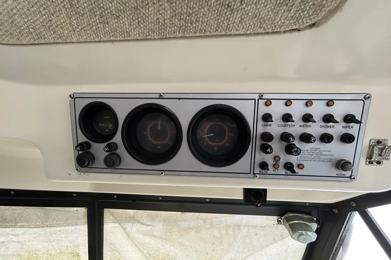 Slide: The Image of 1983 Silverton 34 Convertible control panel with gauges and switches. - 29