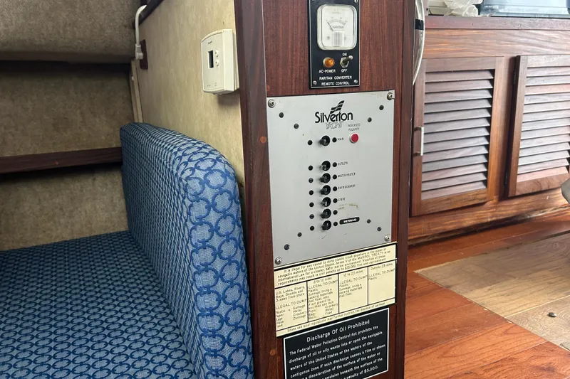 Slide: The Image of 1983 Silverton 34 Convertible interior with control panel and blue patterned seating. - 36