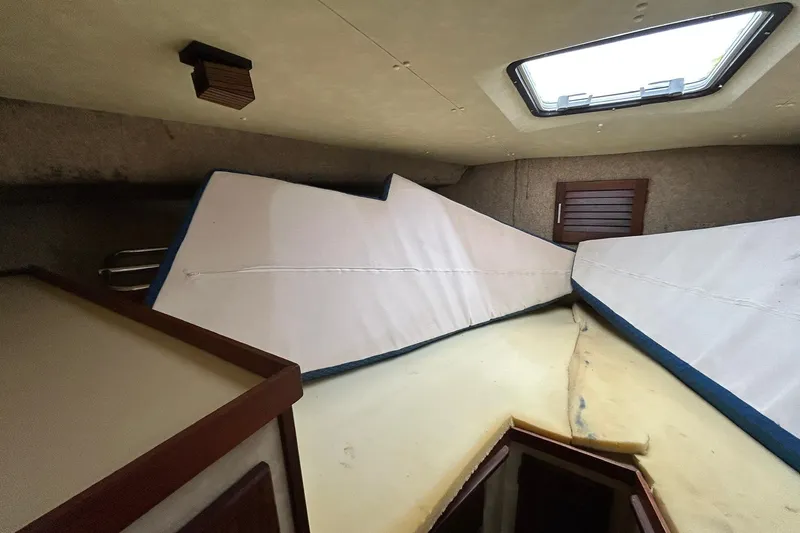 Slide: The Image of Interior cabin of 1983 Silverton 34 Convertible boat with cushions and skylight. - 38