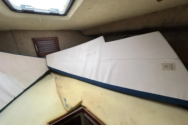 Slide: The Image of Interior cabin of 1983 Silverton 34 Convertible boat with mattress and hatch. - 39