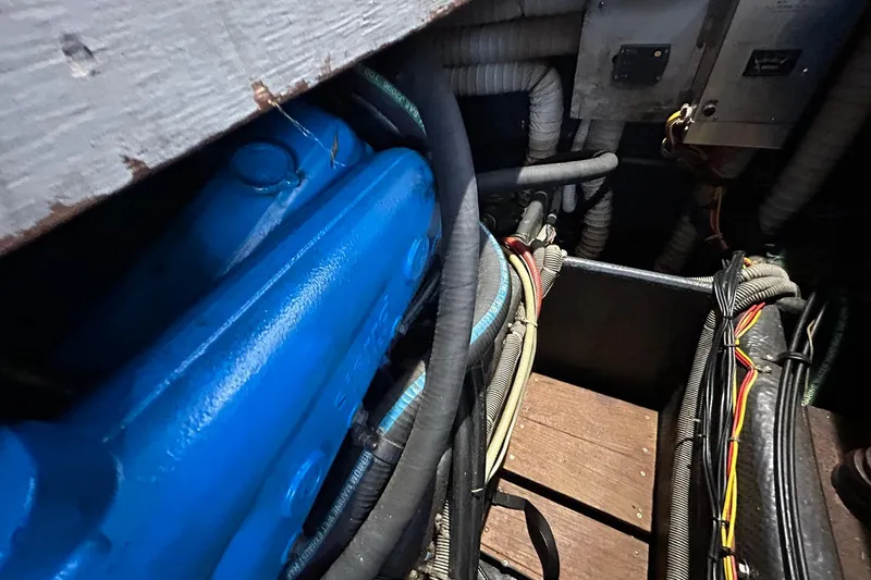Slide: The Image of Engine compartment of 1983 Silverton 34 Convertible with visible wiring and blue engine components. - 42