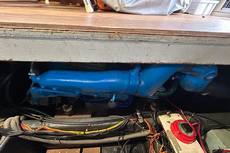 Slide: The Image of 1983 Silverton 34 Convertible engine compartment with blue engine and wiring. - 44