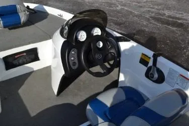 Slide: The Image of 2008 Nitro 640 boat interior with steering wheel and blue-gray seating. - 4