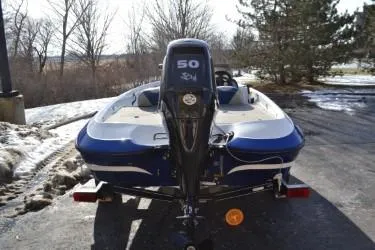 Slide: The Image of 2008 Nitro 640 boat with 50 HP motor on a snowy driveway. - 6