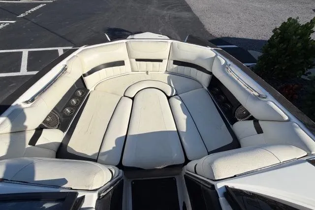 Slide: The Image of 2013 Malibu Wakesetter 24 MXZ boat interior with white seating and cup holders. - 11