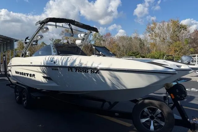 Slide: The Image of 2013 Malibu Wakesetter 24 MXZ boat on trailer under a partly cloudy sky. - 4