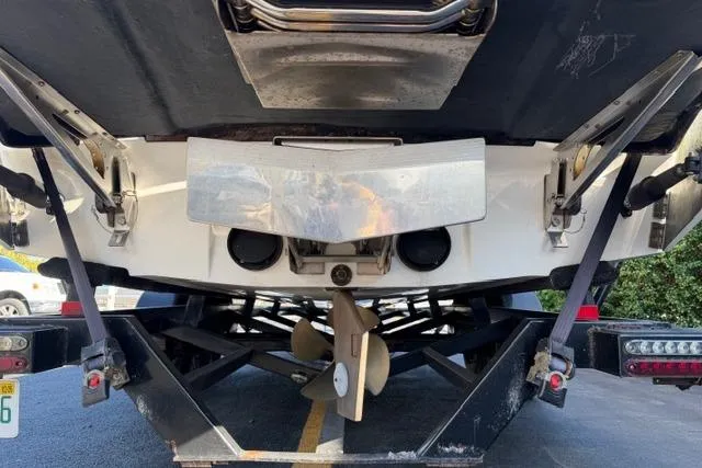 Slide: The Image of Rear view of 2013 Malibu Wakesetter 24 MXZ boat on trailer, showing propeller and hull. - 8