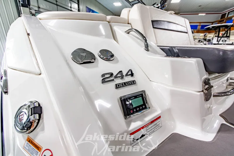 Slide: The Image of 2017 Chaparral 244 Sunesta Deluxe boat interior with control panel and seating. - 10