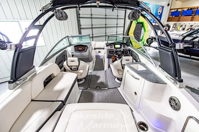 Slide: The Image of 2017 Chaparral 244 Sunesta boat interior with seating, steering console, and modern amenities. - 15