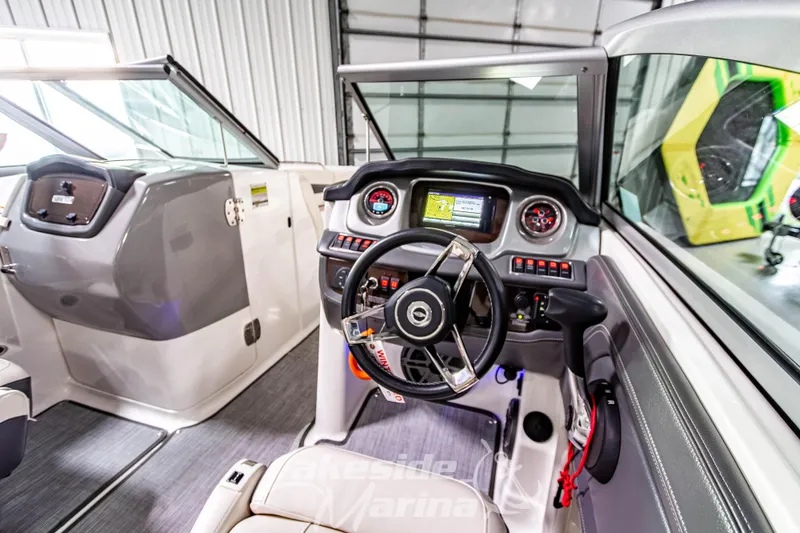 Slide: The Image of 2017 Chaparral 244 Sunesta boat cockpit with modern steering and navigation system. - 23