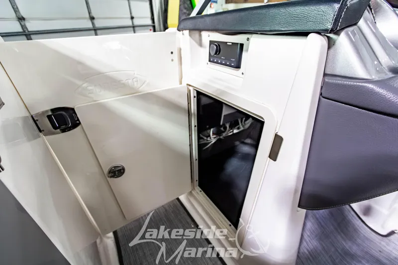 Slide: The Image of 2017 Chaparral 244 Sunesta boat interior storage compartment with open door. - 33