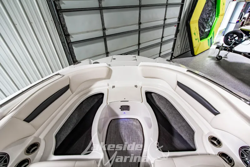 Slide: The Image of 2017 Chaparral 244 Sunesta boat interior with seating and storage compartments. - 37