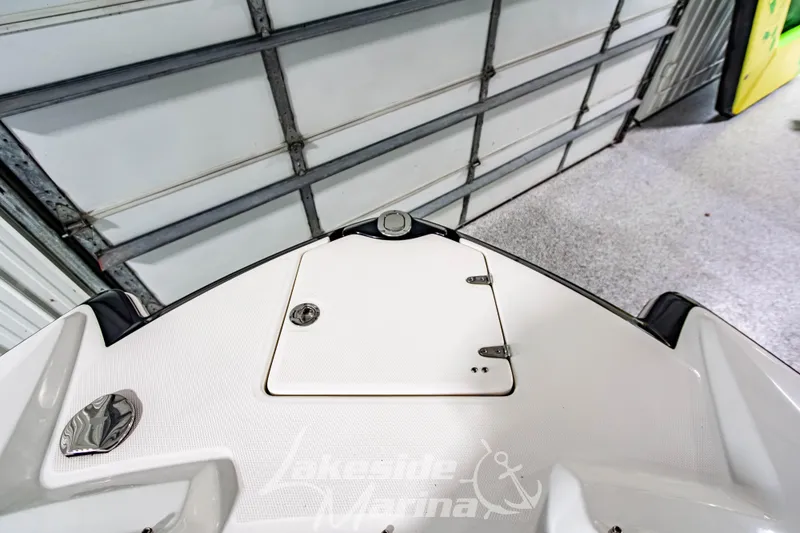 Slide: The Image of 2017 Chaparral 244 Sunesta boat bow in a garage setting. - 40