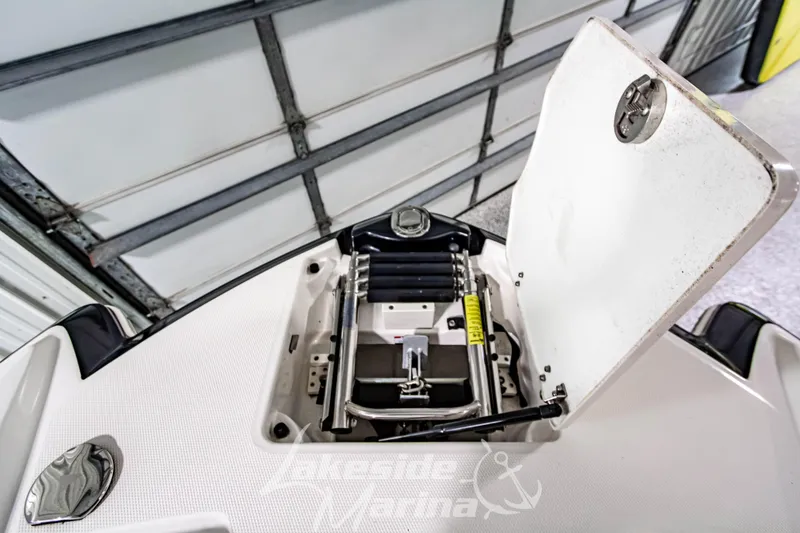 Slide: The Image of 2017 Chaparral 244 Sunesta boat ladder compartment in a garage setting. - 41