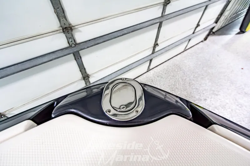 Slide: The Image of 2017 Chaparral 244 Sunesta boat detail in a garage setting. - 43