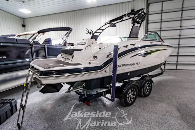 Slide: The Image of 2017 Chaparral 244 Sunesta boat on trailer in indoor marina setting. - 5