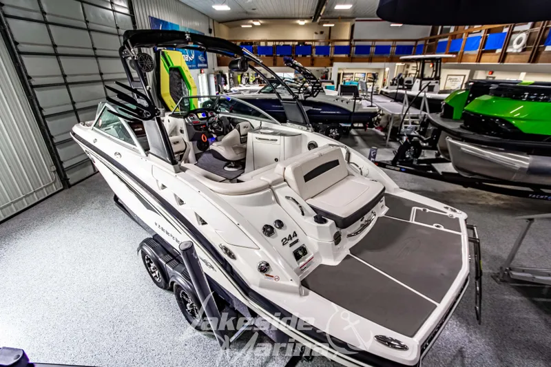 Slide: The Image of 2017 Chaparral 244 Sunesta boat displayed indoors, showcasing sleek design and spacious seating. - 7