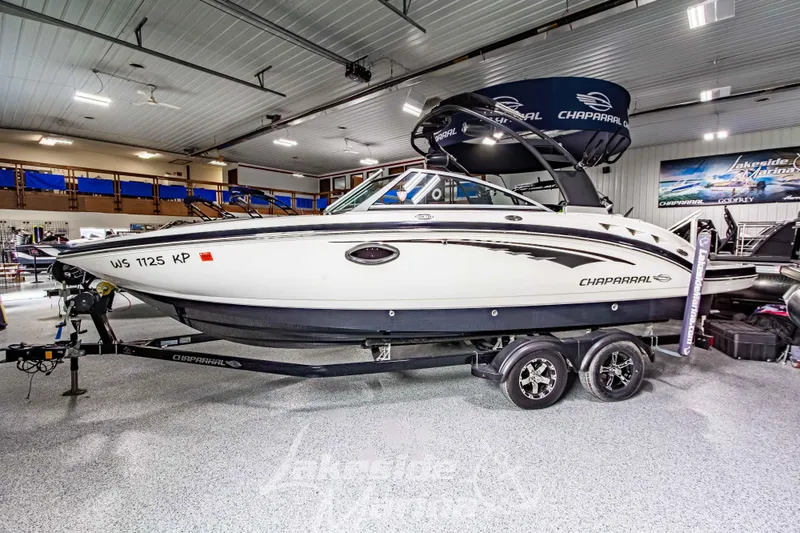 Slide: The Image of 2017 Chaparral 244 Sunesta boat displayed indoors on a trailer. - 9