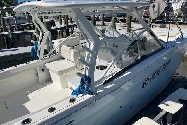 Slide: The Image of 2024 World Cat 280 DC-X boat docked, featuring sleek design and spacious seating. - 3